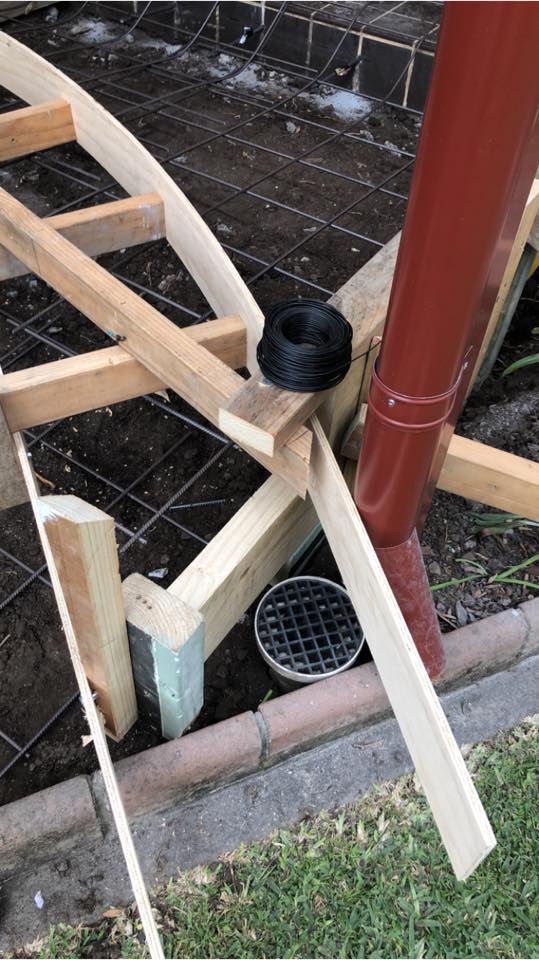 A wooden framework with installed pipes, part of an unfinished construction project.