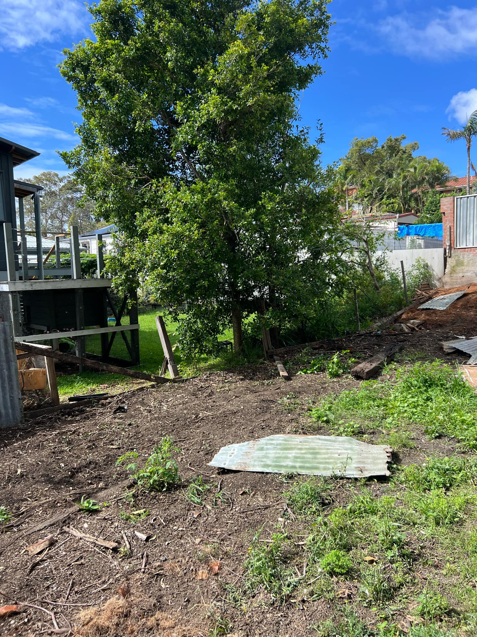 Close-up of concrete foundation with a steel post being installed.